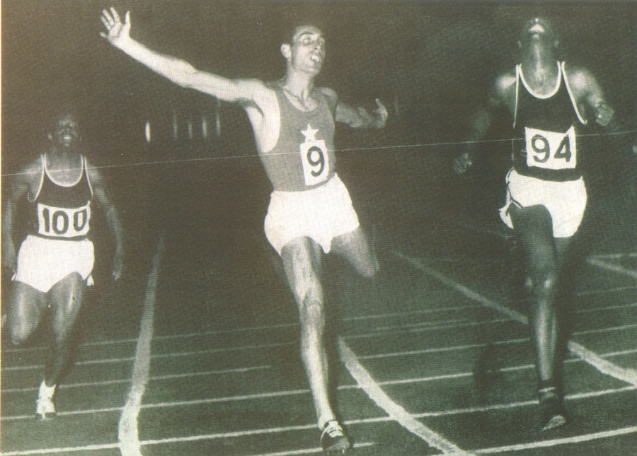 Vincenzo Lombardo, grande esponente della velocità degli anni &#039;50, è stato detentore del primato italiano dei 200 metri dal 1955 al 1959 con il tempo di 21&quot;1, record poi eguagliato e successivamente migliorato da Livio Berruti. La foto ritrae l&#039;atleta sul traguardo dei 200 metri ai Campionati Mondiali Militari CISM di Atene che gli valse il suo primato italiano (1955)